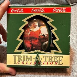 Vintage 1990 Coca-Cola Trim A Tree Santa Oval Tin Ornament